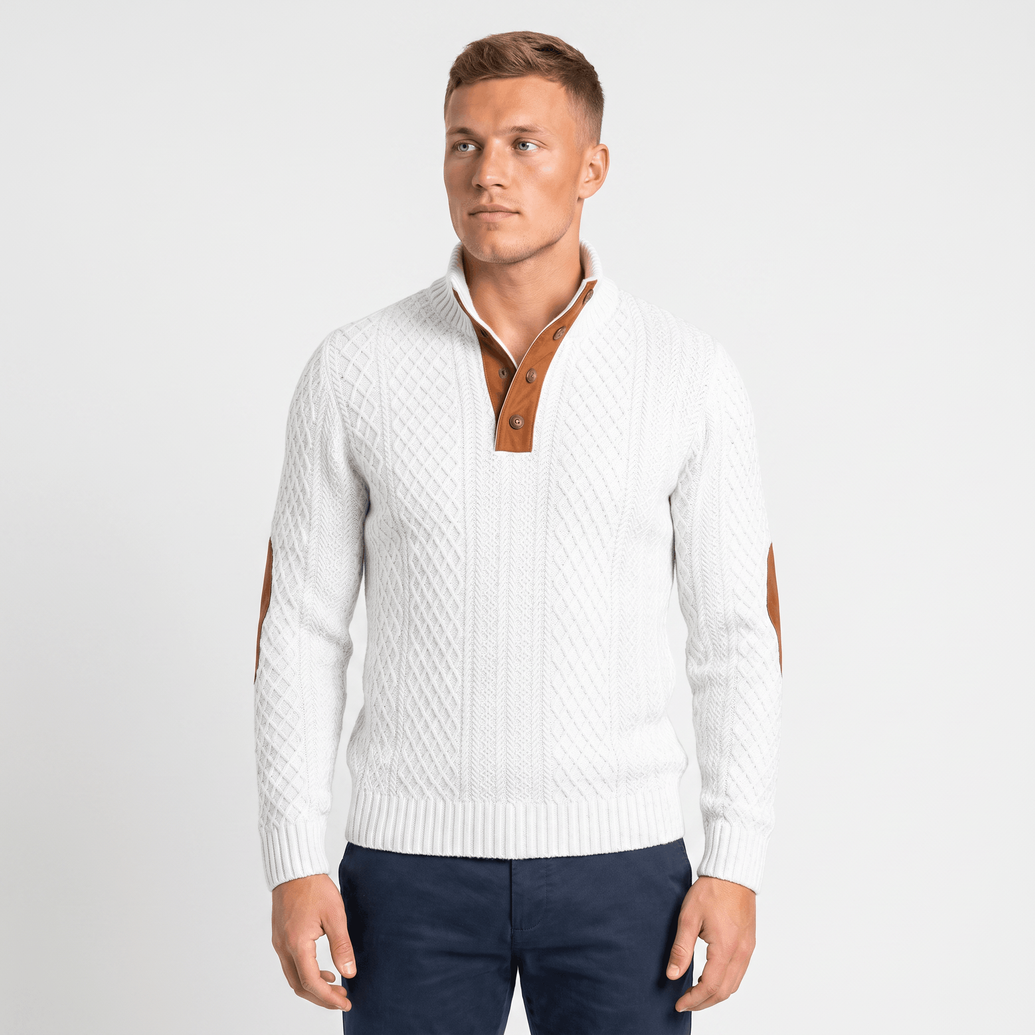 Man wearing a white cable knit Henley sweater with a stand collar, button placket, faux suede elbow patches, and long sleeves.