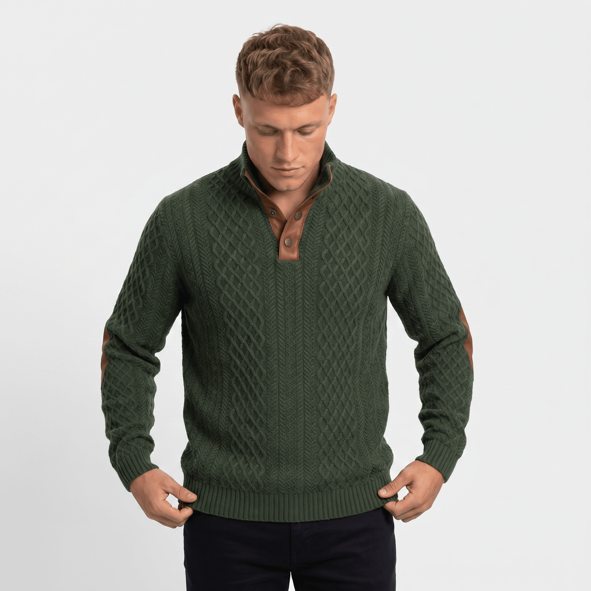 Man wearing a green cable knit Henley sweater with a stand collar, button placket, faux suede elbow patches, and a tailored fit.